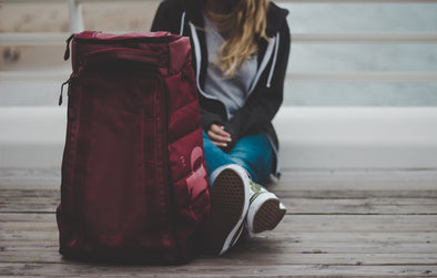 model sitting with packable travel clothes